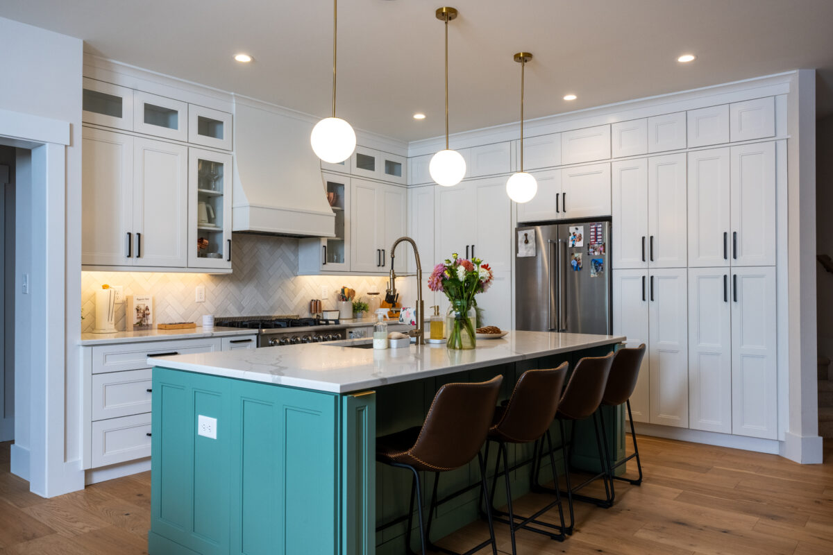 white shaker cabinets with teal island