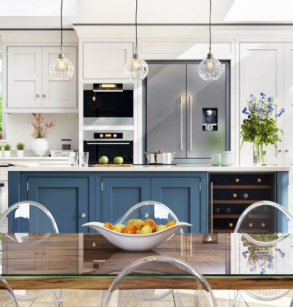A spacious kitchen featuring classic white and blue two-tone cabinets paired with a contemporary seating area.